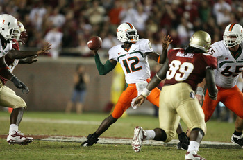TALLAHASSEE, FL - SEPTEMBER 07:  Quarterback Jacory Harris #12 of the Miami Hurricanes throws a touchdown pass in the fourth quarter to Graig Cooper #2 against the Florida State Seminoles at Doak Campbell Stadium on September 7, 2009 in Tallahassee, Flori