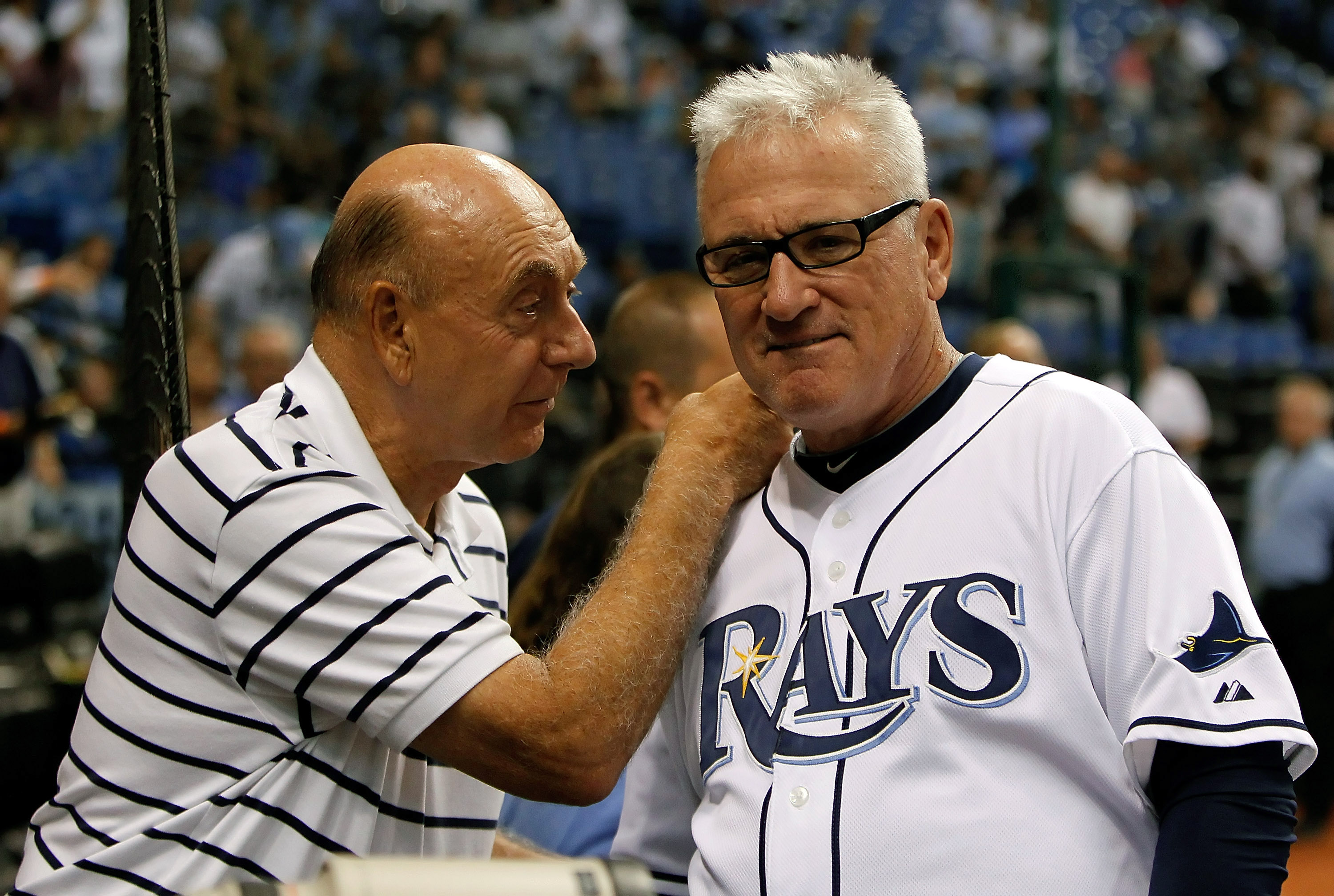 ST. PETERSBURG, FL - SEPTEMBER 28:  Manager Joe Maddon #70 of the Tampa Bay Rays talks with ESPN analyst Dick Vitale just before the start of the game against the Baltimore Orioles at Tropicana Field on September 28, 2010 in St. Petersburg, Florida.  (Pho