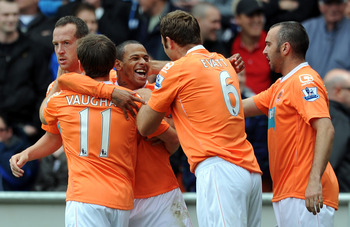 BLACKPOOL, ENGLAND - MAY 14: DJ Campbell of Blackpool is congratulated by his team-mates after scoring the opening goal during the Barclays Premier League match between Blackpool and Bolton Wanderers at Bloomfield Road on May 14, 2011 in Blackpool, Engla