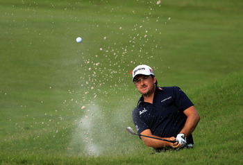 PONTE VEDRA BEACH, FL - MAY 15:  Graeme McDowell of Northern Ireland hits from a bunker on the 11th hole during the final round of THE PLAYERS Championship held at THE PLAYERS Stadium course at TPC Sawgrass on May 15, 2011 in Ponte Vedra Beach, Florida.