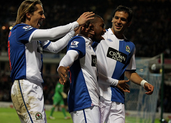 BLACKBURN, ENGLAND - JANUARY 23: Junior Hoilett of Blackburn Rovers celebrates with his team mates Roque Santa Cruz and Michel Salgado (L) after scoring his team's second goal during the Barclays Premier League match between Blackburn Rovers and West Bro