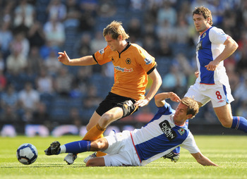 BLACKBURN, ENGLAND - SEPTEMBER 12: Richard Stearman of Wolves battles with Morten Gamst Pedersen of Blackburn Rovers during the Barclays Premier League match between Blackburn Rovers and Wolverhampton Wanderers at Ewood Park on September 12, 2009 in Black