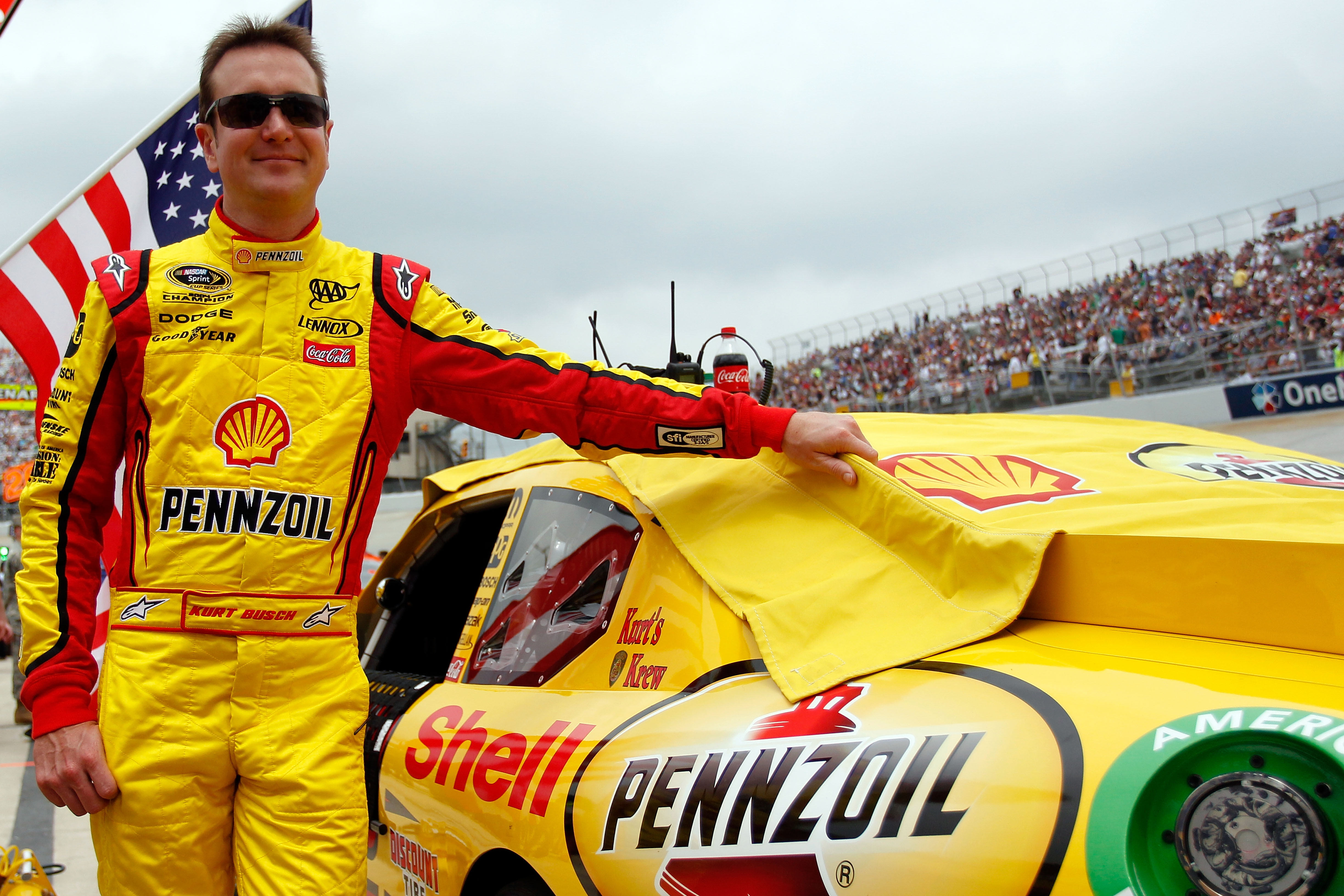 DOVER, DE - MAY 15:  Kurt Busch, driver of the #22 Shell/Pennzoil Dodge, stands next to his car on the grid prior the NASCAR Sprint Cup Series FedEx 400 Benefiting Autism Speaks at Dover International Speedway on May 15, 2011 in Dover, Delaware.  (Photo b
