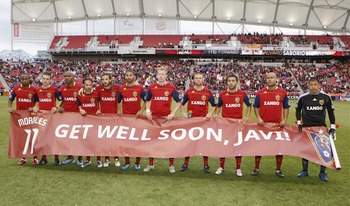 SANDY, UT - MAY 14: Members of Real Salt Lake pose for a picture before a game against The Houston Dynamo at an MLS soccer game May 14, 2011 at Rio Tinto Stadium in Sandy, Utah. They are holding a sign wishing their teammate Javier Morales well after he b
