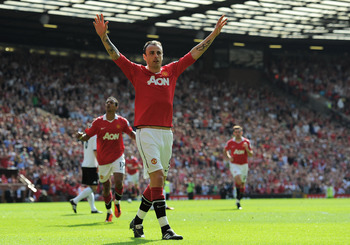 MANCHESTER, ENGLAND - APRIL 09:  Dimitar Berbatov of Manchester United celebrates scoring the opening goal during the Barclays Premier League match between Manchester United and Fulham at Old Trafford on April 9, 2011 in Manchester, England.  (Photo by Mi