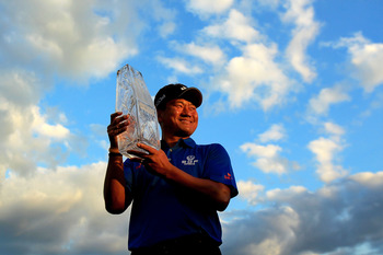 PONTE VEDRA BEACH, FL - MAY 15:  K.J. Choi of South Korea celebrates with the trophy after defeating David Toms on the first playoff hole to win THE PLAYERS Championship held at THE PLAYERS Stadium course at TPC Sawgrass on May 15, 2011 in Ponte Vedra Bea
