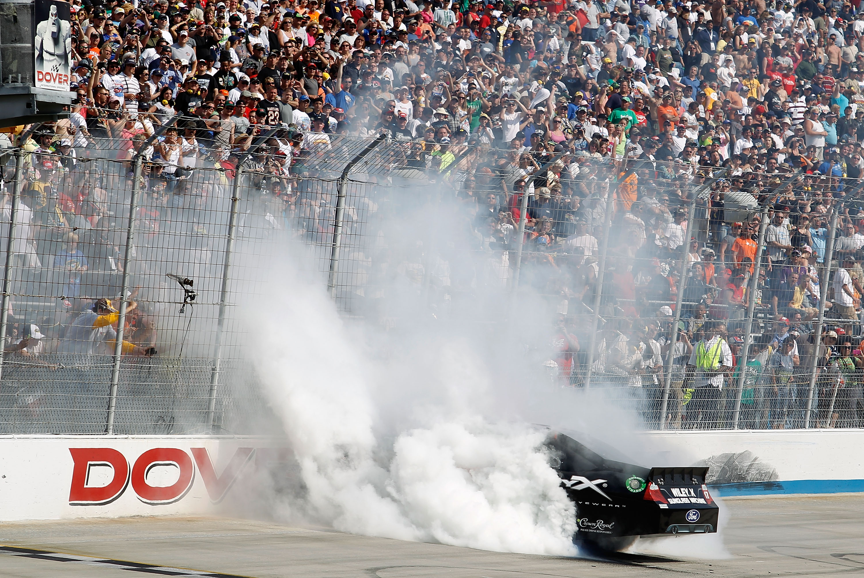 DOVER, DE - MAY 15:  Matt Kenseth, driver of the #17 Wiley X Sunglasses Ford, celebrates with a burnout after winning the NASCAR Sprint Cup Series FedEx 400 Benefiting Autism Speaks at Dover International Speedway on May 15, 2011 in Dover, Delaware.  (Pho