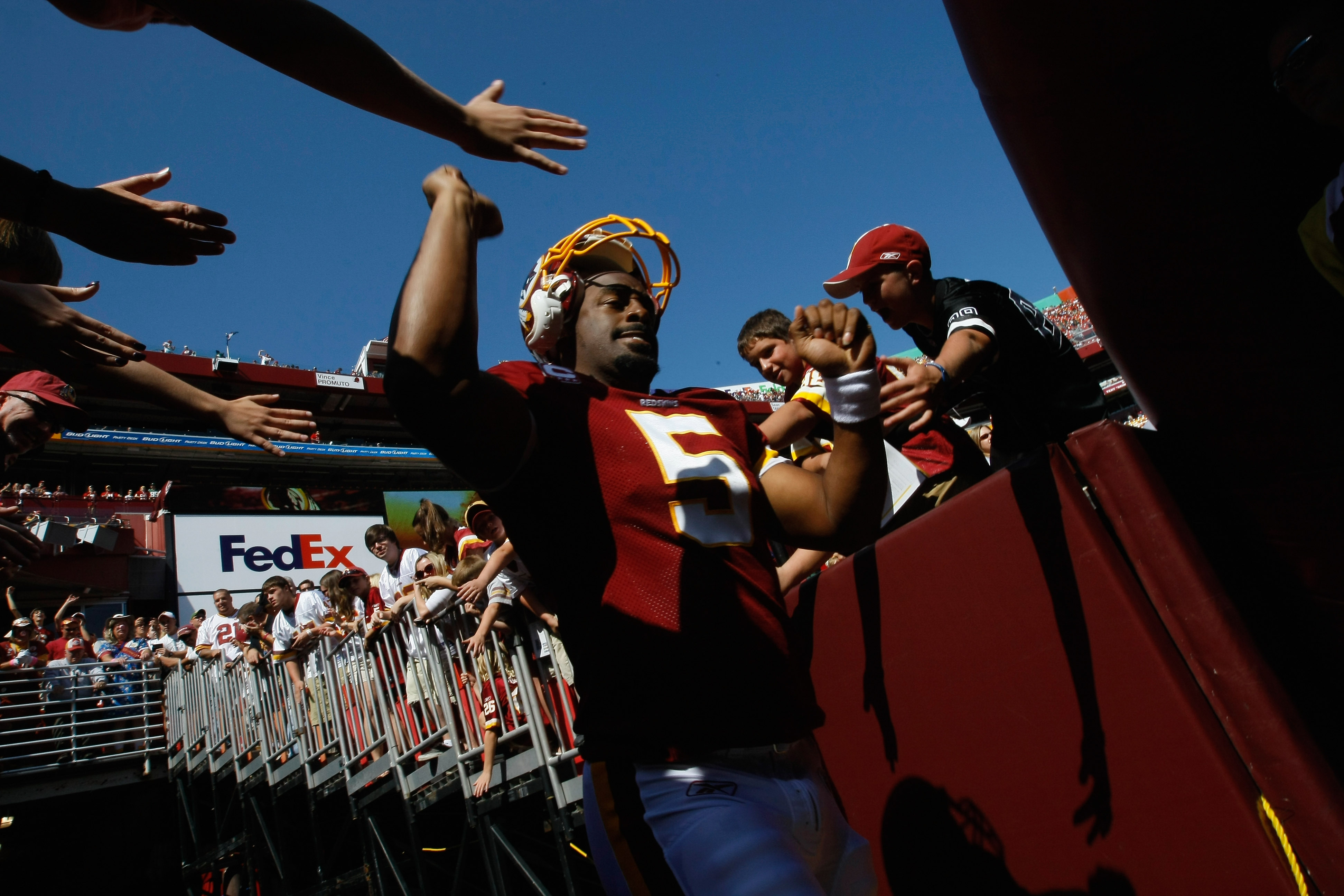 LANDOVER, MD - OCTOBER 10:  Quarterback Donovan McNabb #5 of the Washington Redskins greets fans before playing against the Green Bay Packers at FedExField on October 10, 2010 in Landover, Maryland.  (Photo by Win McNamee/Getty Images)