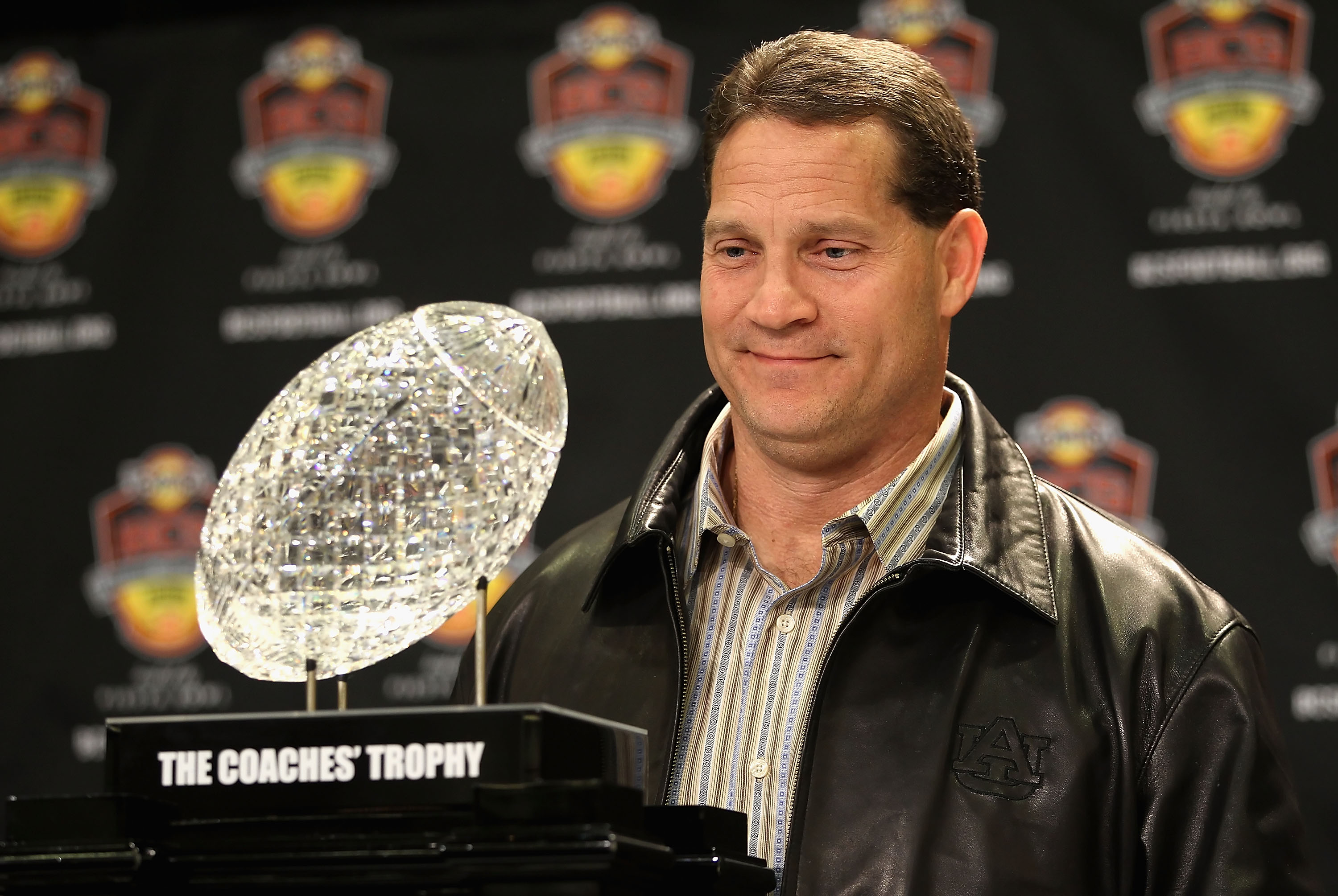 SCOTTSDALE, AZ - JANUARY 11:  Head coach Gene Chizik of the Auburn Tigers poses with the Coaches trophys during a press conference for the Tostitos BCS National Championship Game at the JW Marriott Camelback Inn on January 11, 2011 in Scottsdale, Arizona.