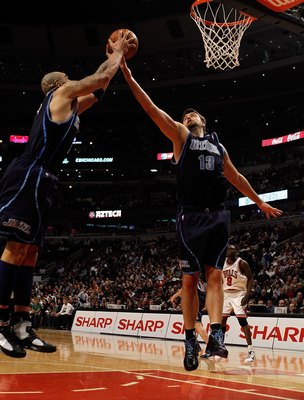 CHICAGO - MARCH 09: Carlos Boozer #5 and Mehmet Okur #13 of the Utah Jazz leap for a rebound against the Chicago Bulls at the United Center on March 9, 2010 in Chicago, Illinois. The Jazz defeated the Bulls 132-108. NOTE TO USER: User expressly acknowledg