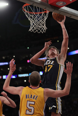 LOS ANGELES, CA - JANUARY 25:  Andrei Kirilenko #47 of the Utah Jazz drives to the basket over Steve Blake #5 of the Los Angeles Lakers in the first half at Staples Center on January 25, 2011 in Los Angeles, California. The Lakers defeated the Jazz 120-91