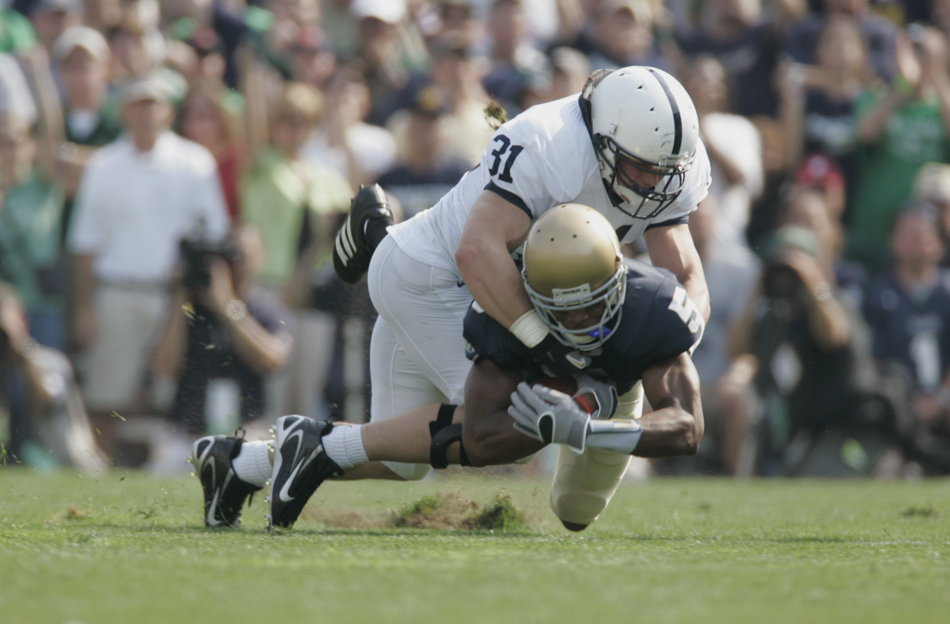SOUTH BEND, IN - SEPTEMBER 9: Wide receiver Rhema McKnight #5 of the Notre Dame Fighting Irish is tackled by linebacker Paul Posluszny #31 of the Penn State Nittany Lions on September 9, 2006 at Notre Dame Stadium in South Bend, Indiana. (Photo By Gregor
