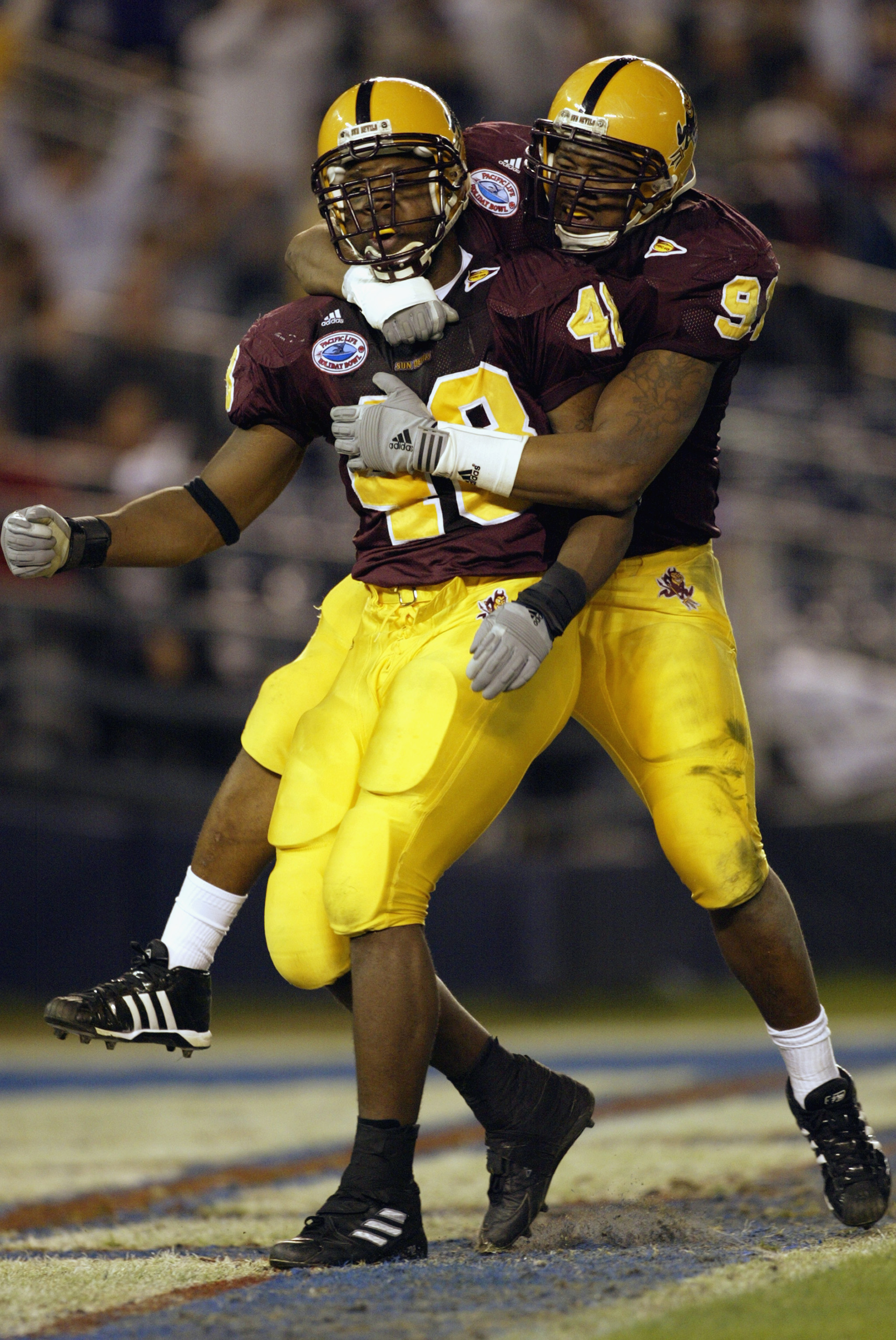 SAN DIEGO - DECEMBER 27: Terrell Suggs #48 and Jimmy Verdon #91 of the Arizona State Sun Devils celebrate during the Pacific Life Holiday Bowl against the Kansas State Wildcats at Qualcomm Stadium on December 27, 2002 in San Diego, California. The Wildc