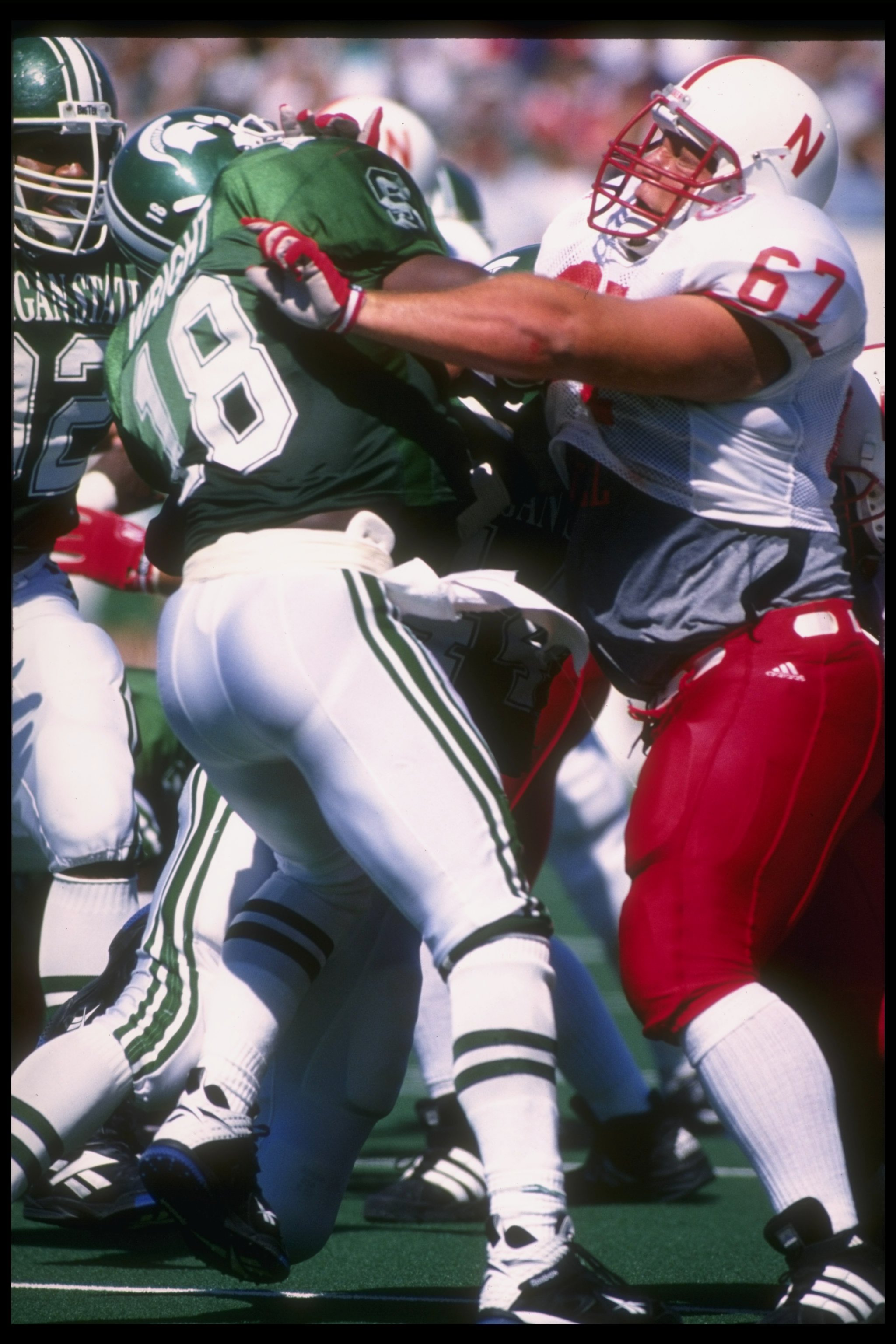9 Sep 1995: Center Aaron Taylor of the Nebraska Cornhuskers (right) blocks safety Marvin Wright of the Michigan State Spartans during a game at Spartan Stadium in East Lansing, Michigan. Nebraska won the game, 50-10. Mandatory Credit: Jonathan Daniel /