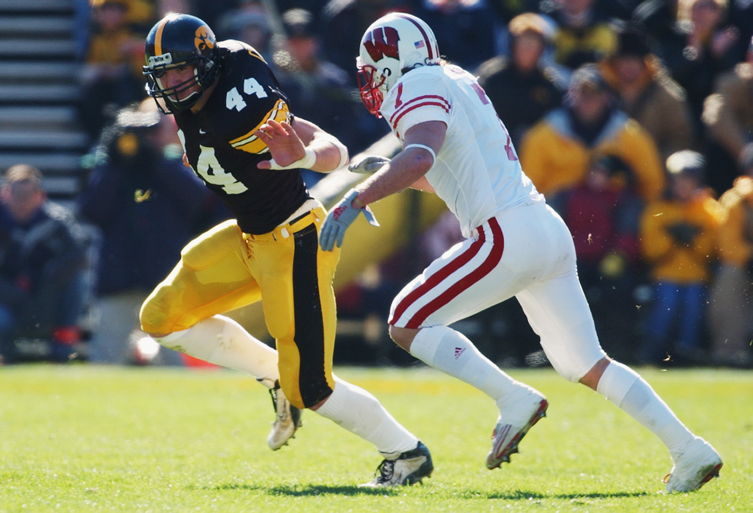 IOWA CITY, IOWA - NOVEMBER 2: Defensive back Ryan Aiello #7 of the Wisconsin Badgers chases tight end Dallas Clark #44 of the Iowa Hawkeyes during the Big 10 Conference football game at Kinnick Stadium on November 2, 2002 in Iowa City, Iowa. The Hawkeye