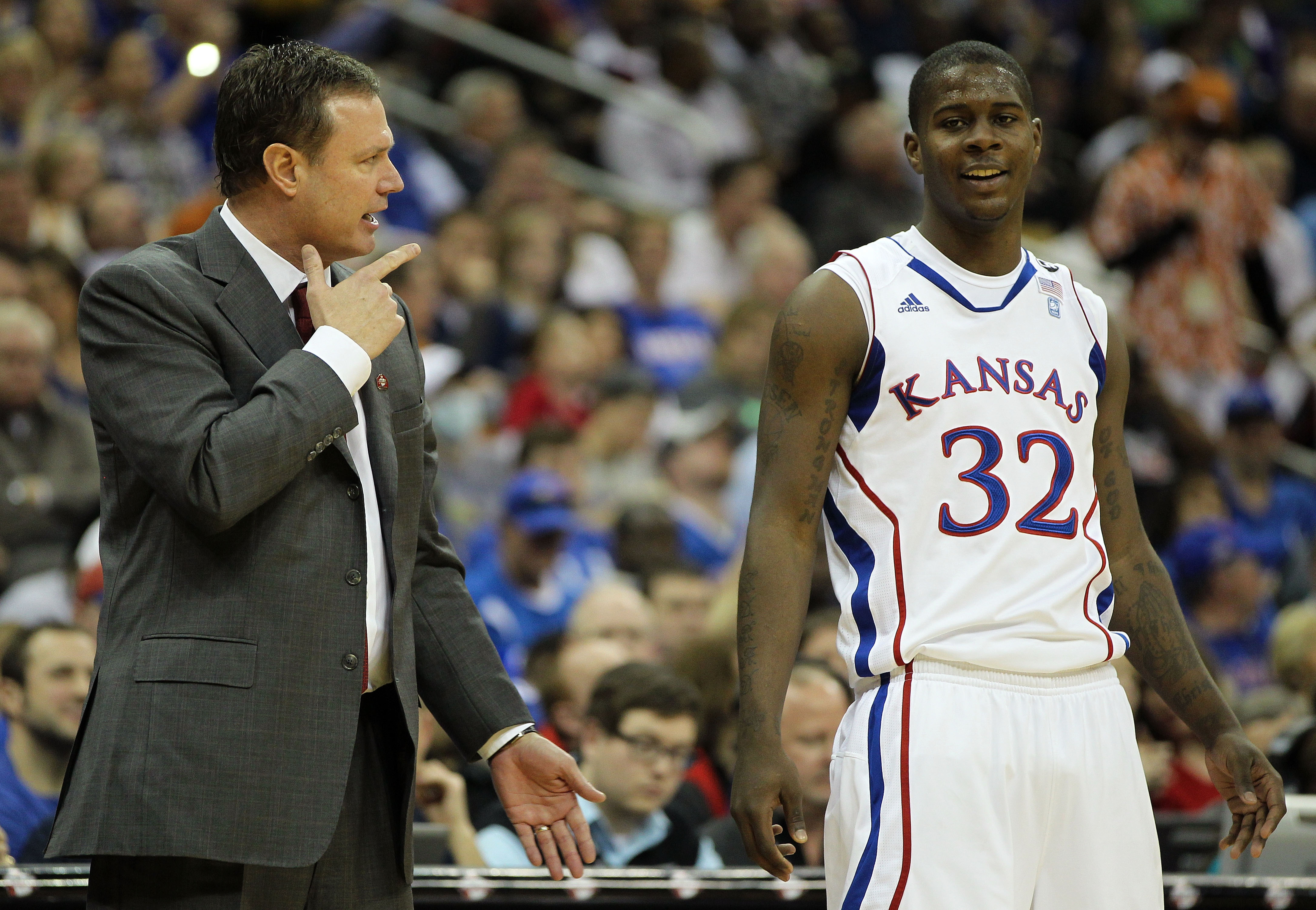 KANSAS CITY, MO - MARCH 11:  Head coach Bill Self of the Kansas Jayhawks speaks with Josh Selby #32  during their semifinal game against the Colorado Buffaloes in the 2011 Phillips 66 Big 12 Men's Basketball Tournament at Sprint Center on March 11, 2011 i