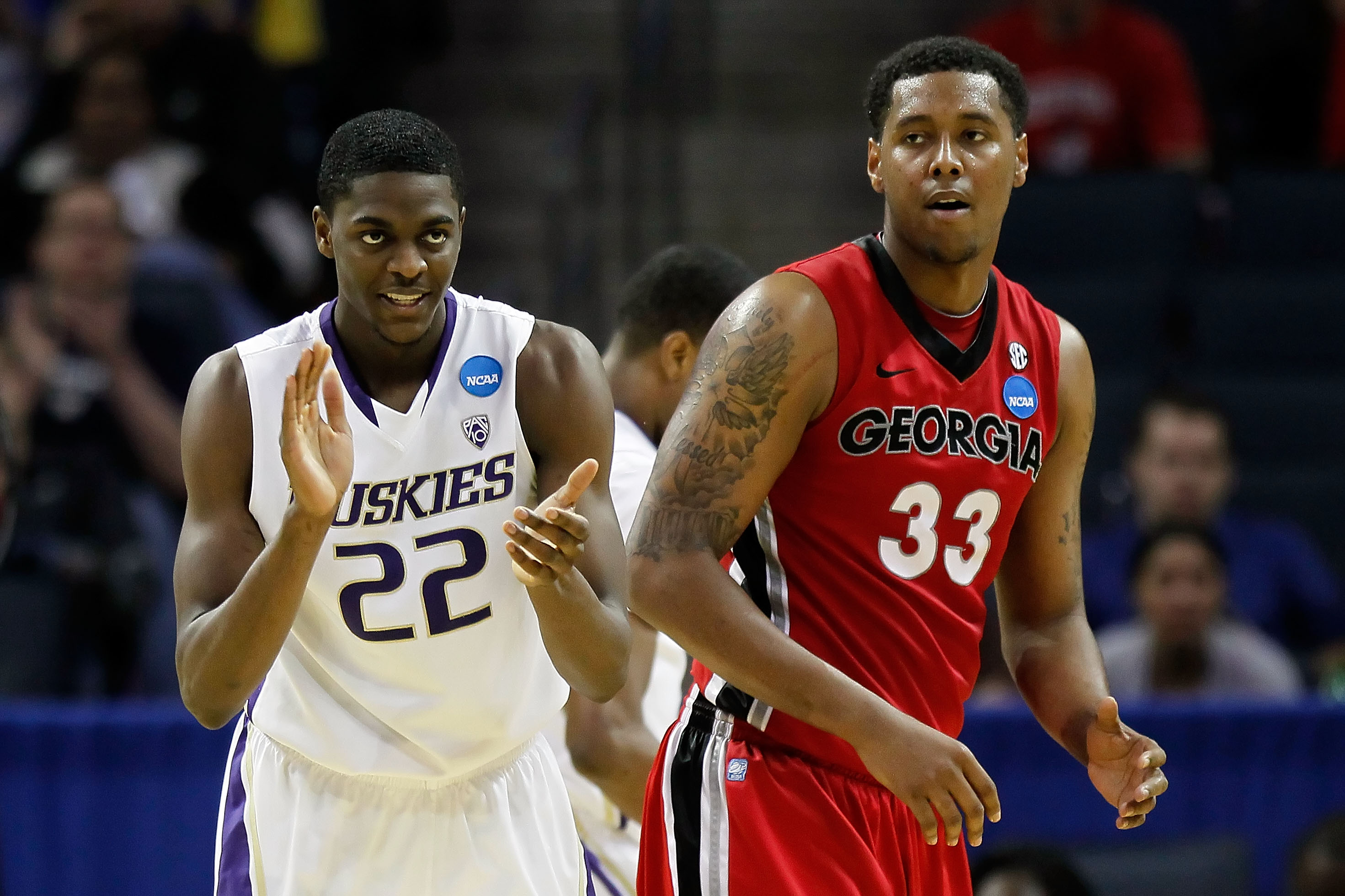 CHARLOTTE, NC - MARCH 18:  Justin Holiday #22 of the Washington Huskies reacts alongside Trey Thompkins #33 of the Georgia Bulldogs in the second half during the second round of the 2011 NCAA men's basketball tournament at Time Warner Cable Arena on March
