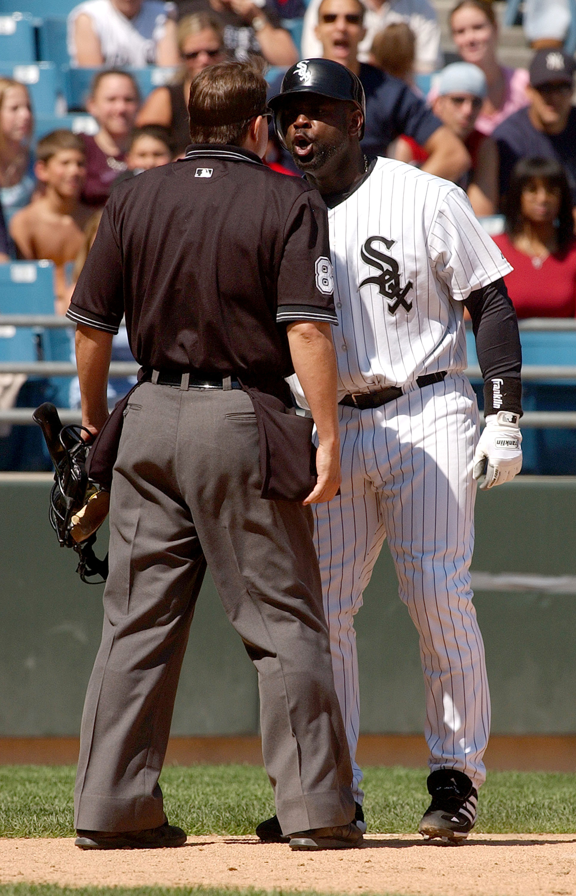 CHICAGO - AUGUST 21:  Carl Everett #8 of the Chicago White Sox argues with home plate umpire Doug Eddings #88 after striking out with the bases loaded in the sixth inning during a game against the Boston Red Sox on August 21, 2004 at U.S. Cellular Field i