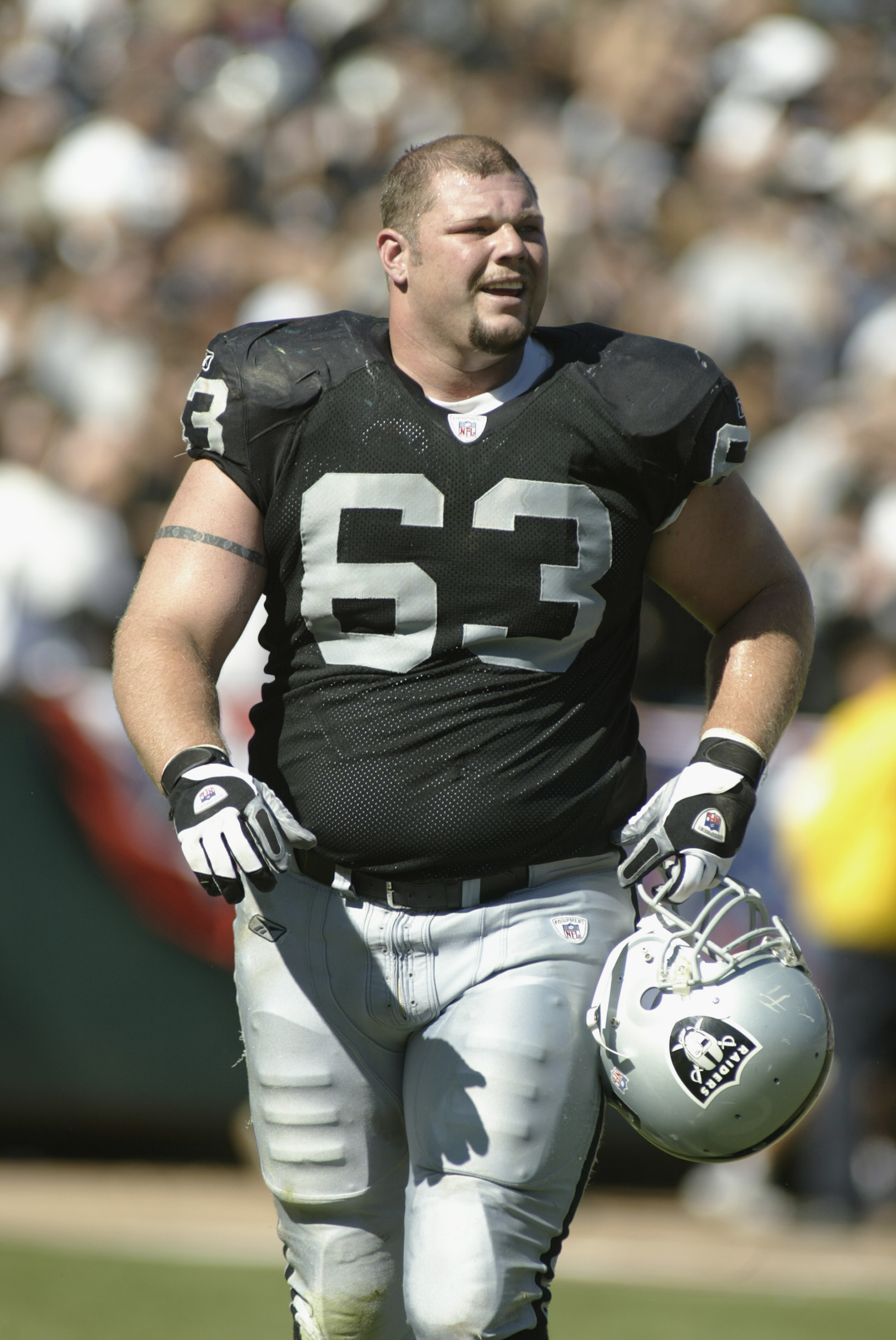 OAKLAND, CA - SEPTEMBER  8:  Center Barret Robbins #63 of the Oakland Raiders walks on the field during the game against the Seattle Seahawks on September 8, 2002 at Network Associates Coliseum in Oakland, California. The Raiders won 31-17. (Photo By Scot