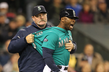 SEATTLE - MAY 06:  Milton Bradley #15 of the Seattle Mariners is restrained by manager Eric Wedge #22 after being ejected from the game against the Chicago White Sox at Safeco Field on May 6, 2011 in Seattle, Washington. The Mariners won 3-2. (Photo by Ot
