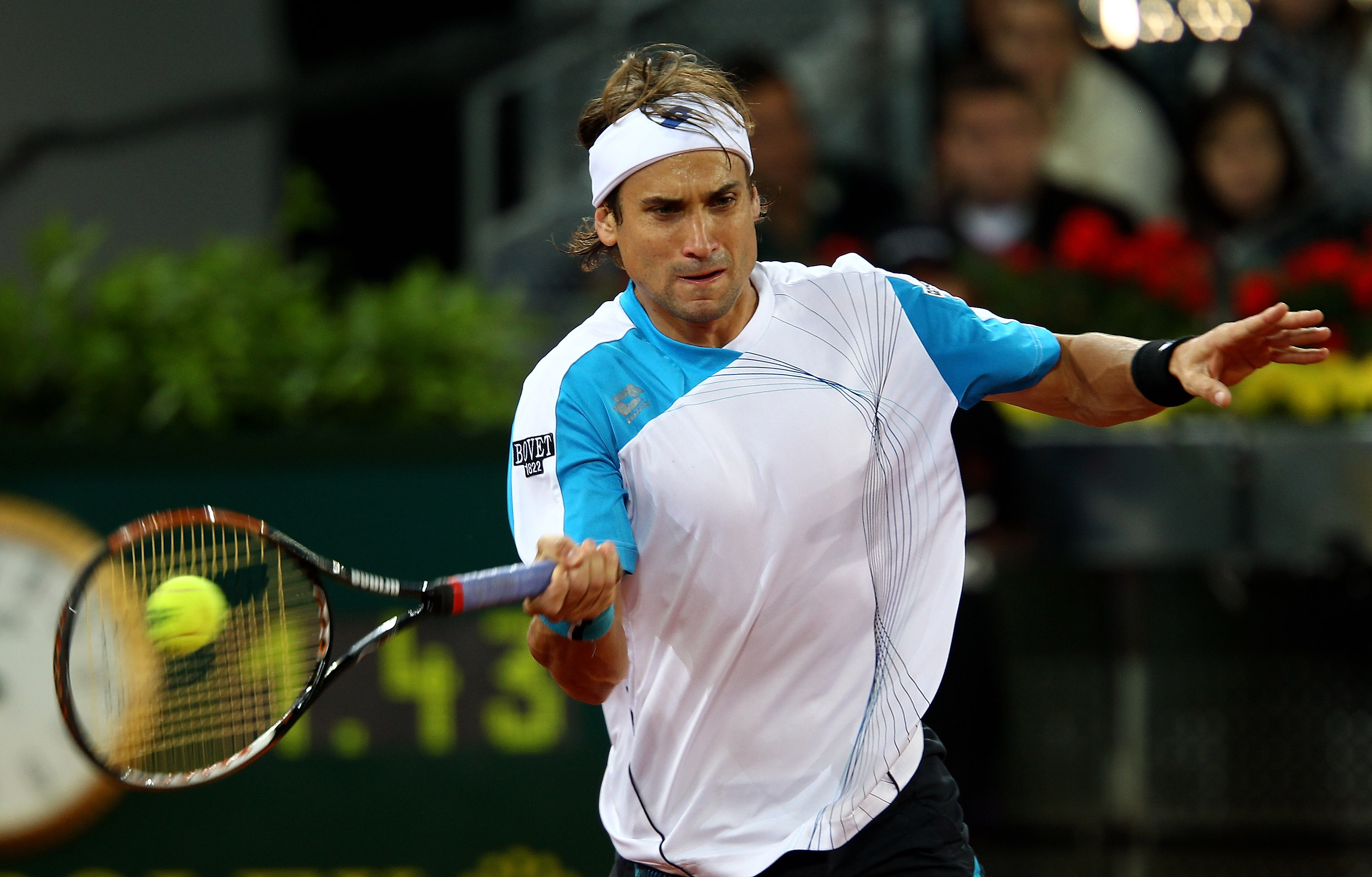 MADRID, SPAIN - MAY 15:  David Ferrer of Spain plays a forehand against Roger Federer of Switzerland in their semi final match during the Mutua Madrilena Madrid Open tennis tournament at the Caja Magica on May 15, 2010 in Madrid, Spain.  (Photo by Clive B