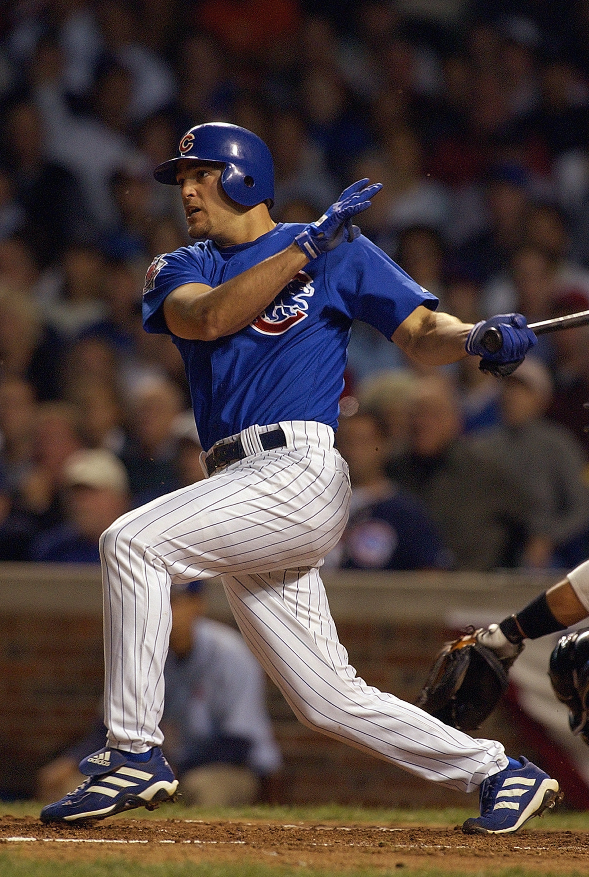 CHICAGO - OCTOBER 7:  Shortstop Alex Gonzalez #8 of the Chicago Cubs hits a home run in the sixth inning of game one of the National League Championship Series against the Florida Marlins on October 7, 2003 at Wrigley Field in Chicago, Illinois. The Marli