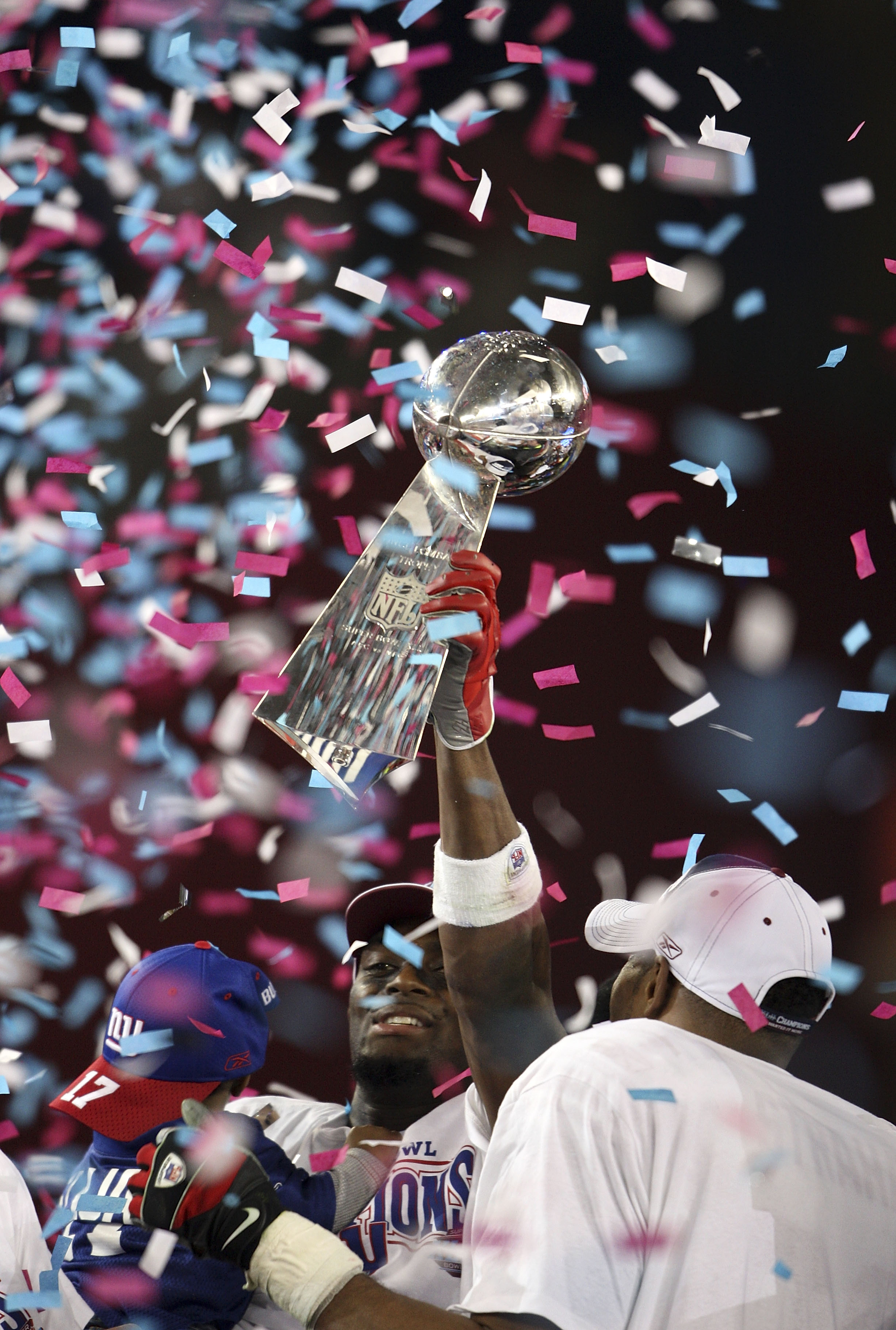 GLENDALE, AZ - FEBRUARY 03:  Wide receiver Plaxico Burress #17 of the New York Giants holds the Vince Lombardi Trophy after defeating the New England Patriots 17-14 in Super Bowl XLII on February 3, 2008 at the University of Phoenix Stadium in Glendale, A