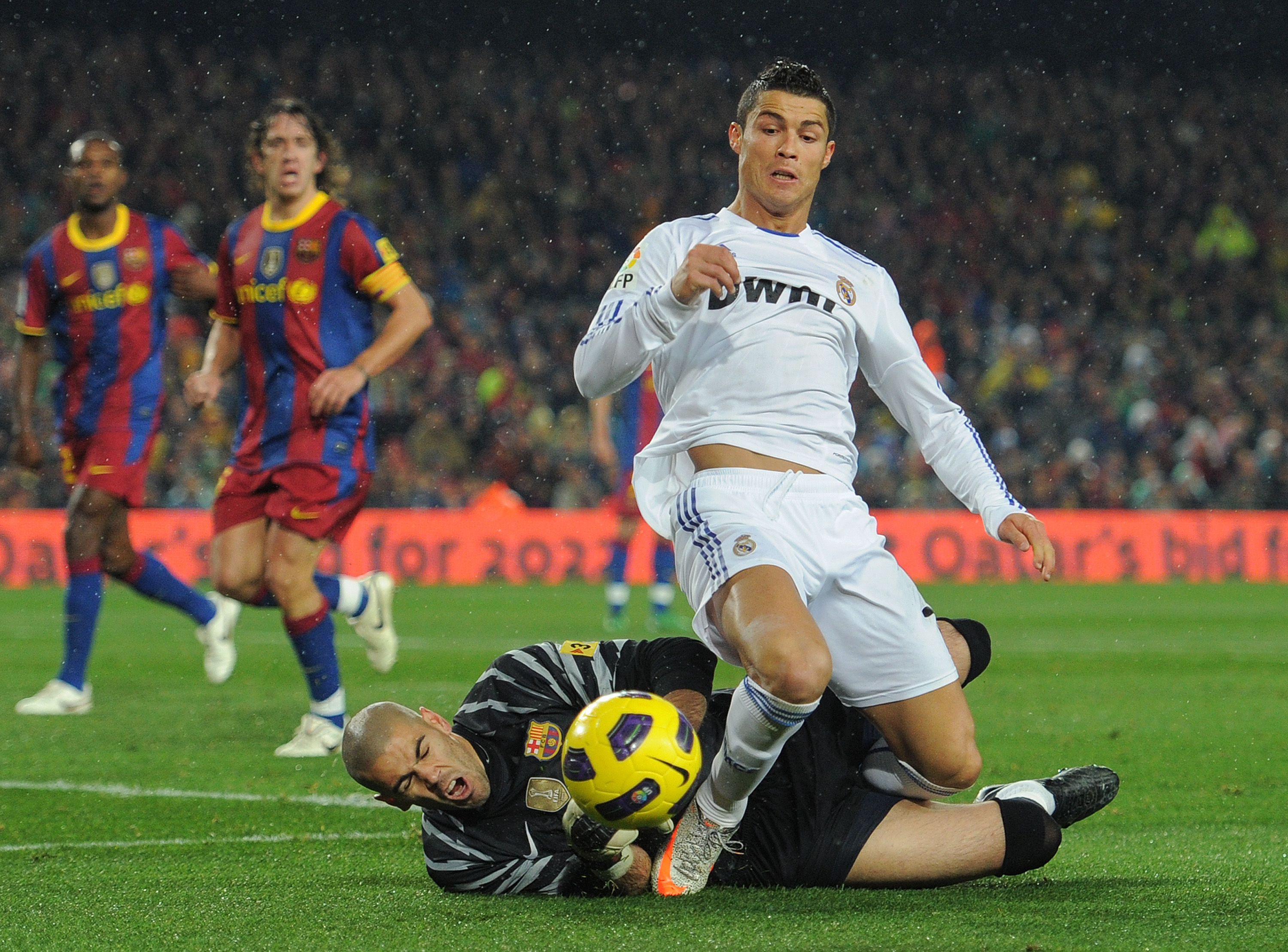 BARCELONA, SPAIN - NOVEMBER 29:  Cristiano Ronaldo (R) of Real Madrid is fouled in the penalty aeria by goalkeeper Victor Valdes of Barcelona during the la liga match between Barcelona and Real Madrid at the Camp Nou stadium on November 29, 2010 in Barcel