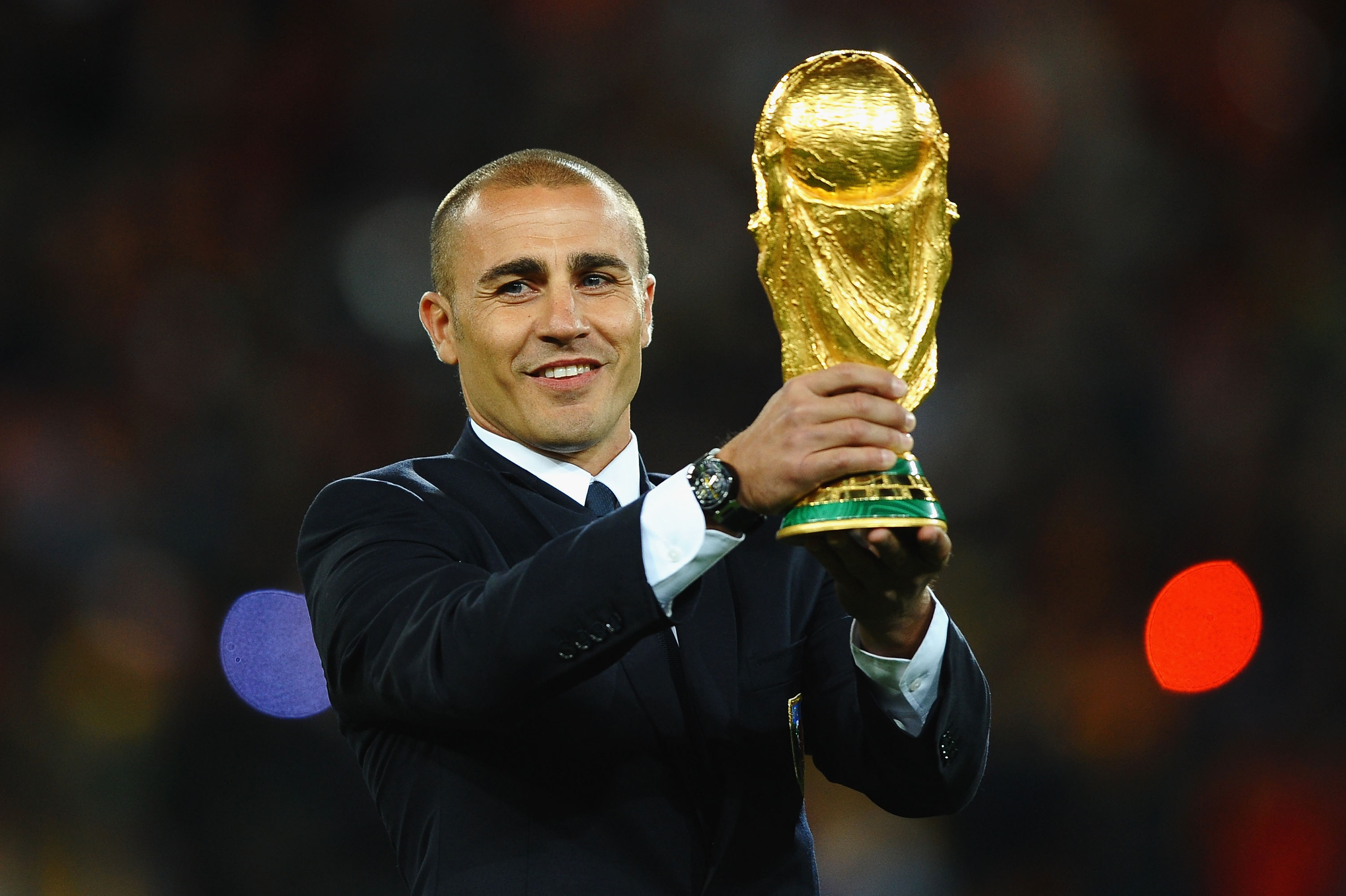 JOHANNESBURG, SOUTH AFRICA - JULY 11:  Fabio Cannavaro of Italy presents the World Cup trophy prior to the 2010 FIFA World Cup South Africa Final match between Netherlands and Spain at Soccer City Stadium on July 11, 2010 in Johannesburg, South Africa.  (