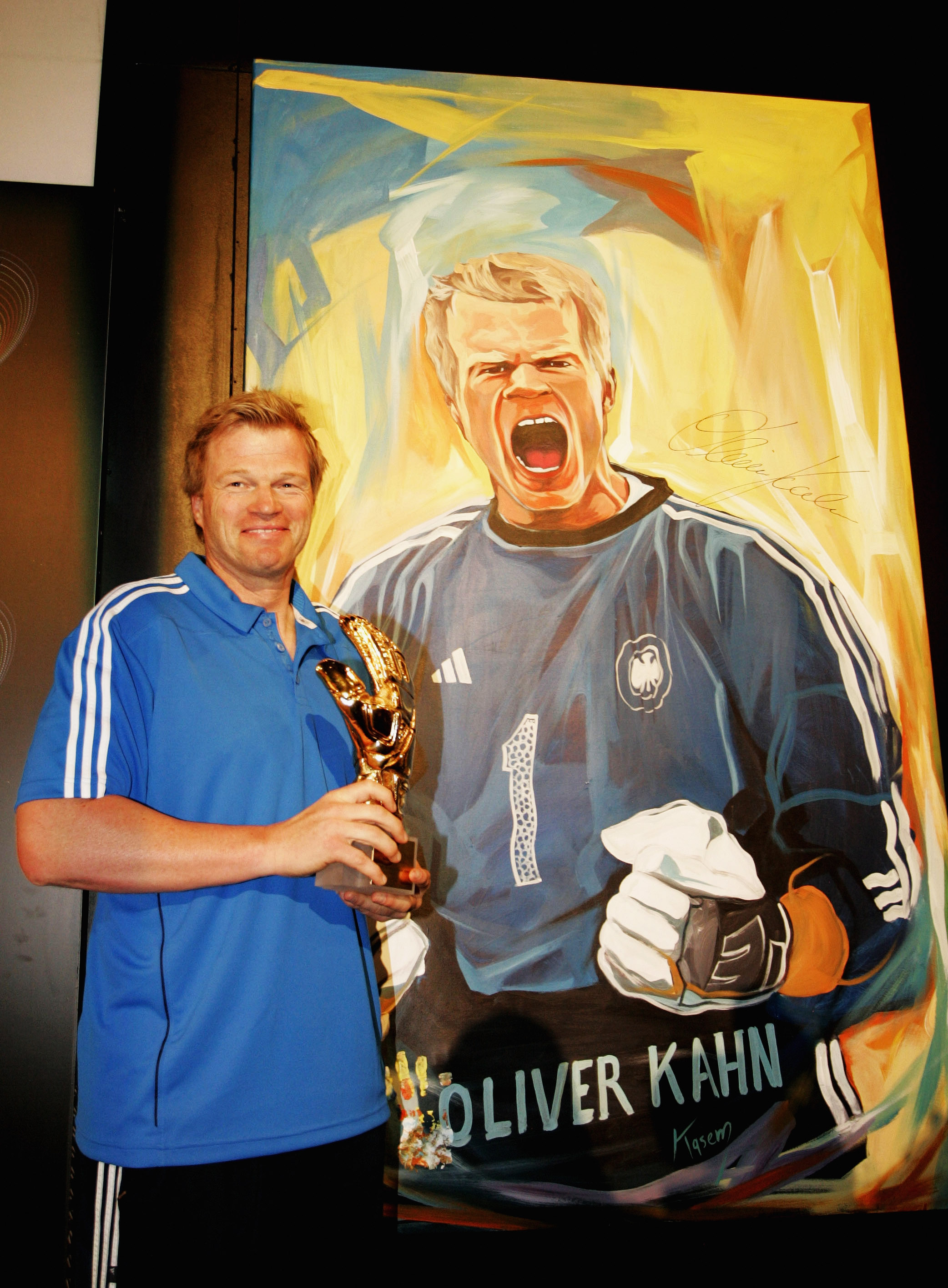 SANDTON, SOUTH AFRICA - JUNE 25:  Oliver Kahn poses in front of a portrait of himself to be auctioned, during the adidas Penalty Day at the Jo'bulani Centre on June 25, 2010 in Sandton, South Africa.  (Photo by Dominic Barnardt/Getty Images for adidas)