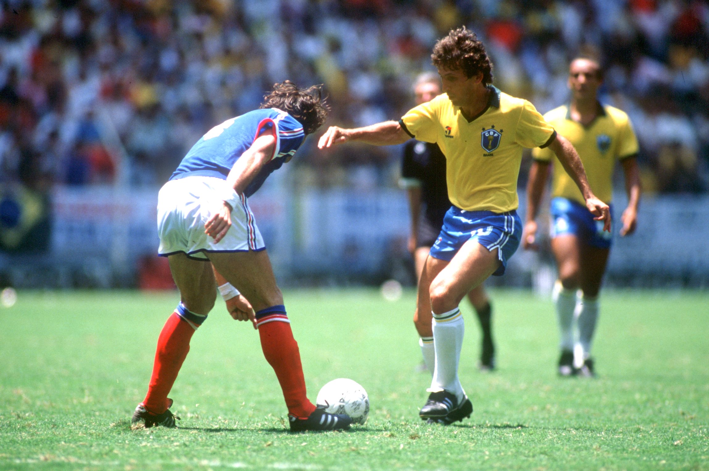 JUN 1986:  ZICO OF BRAZIL TAKES ON AN UNIDENTIFIED FRENCH DEFENDER DURING THE 1986 WORLD CUP IN MEXICO.  BRAZIL BEAT FRANCE 5-4. Mandatory Credit: David Cannon/ALLSPORT