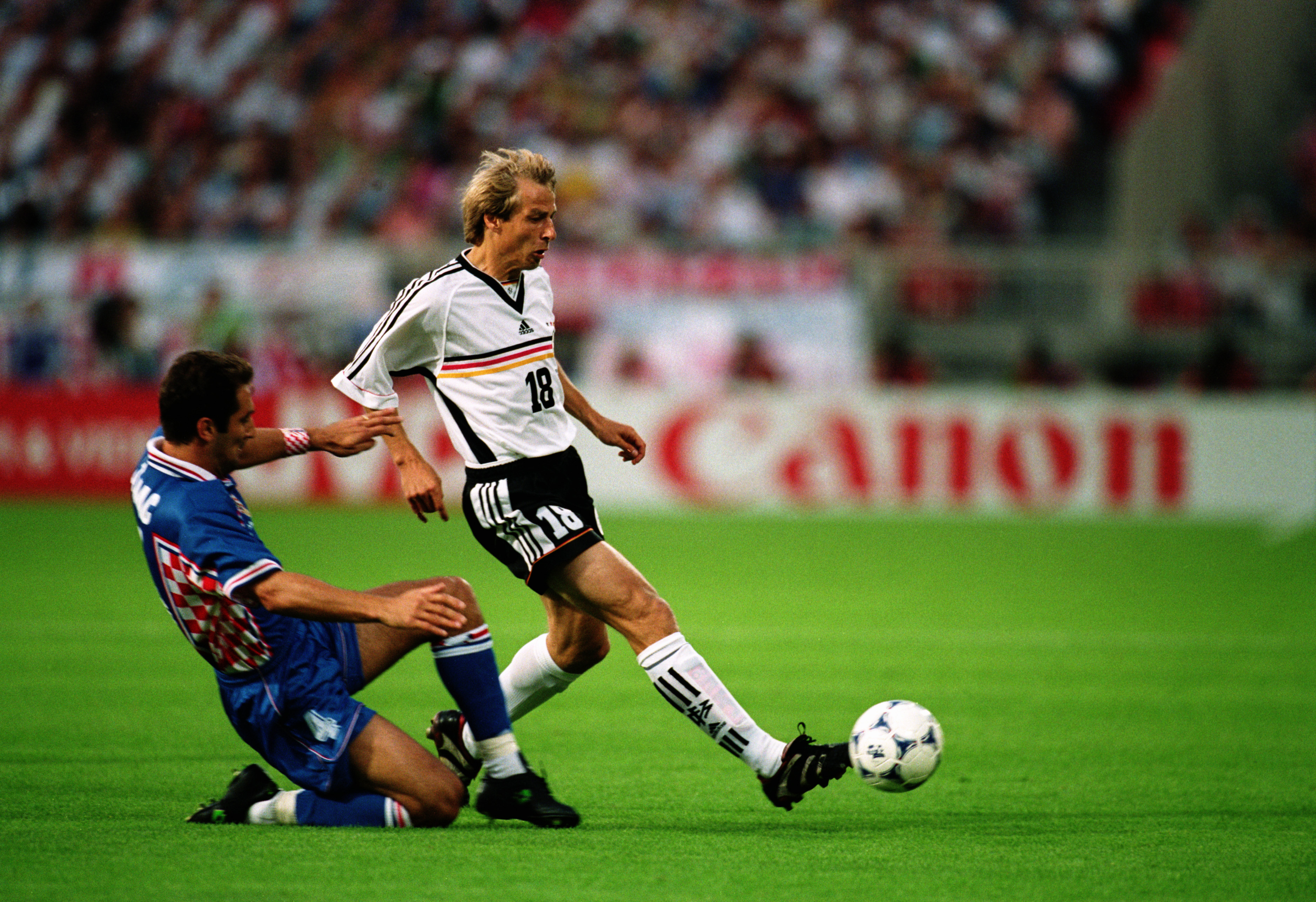 LYON - JULY 4:  Jurgen Klinsmann of Germany passes the ball as Igor Stimac of Croatia makes a challenge during the FIFA World Cup Finals 1998 Quarter Final match between Germany and Croatia held on July 4, 1998 at Stade Gerland, in Lyon, France. Croatia w