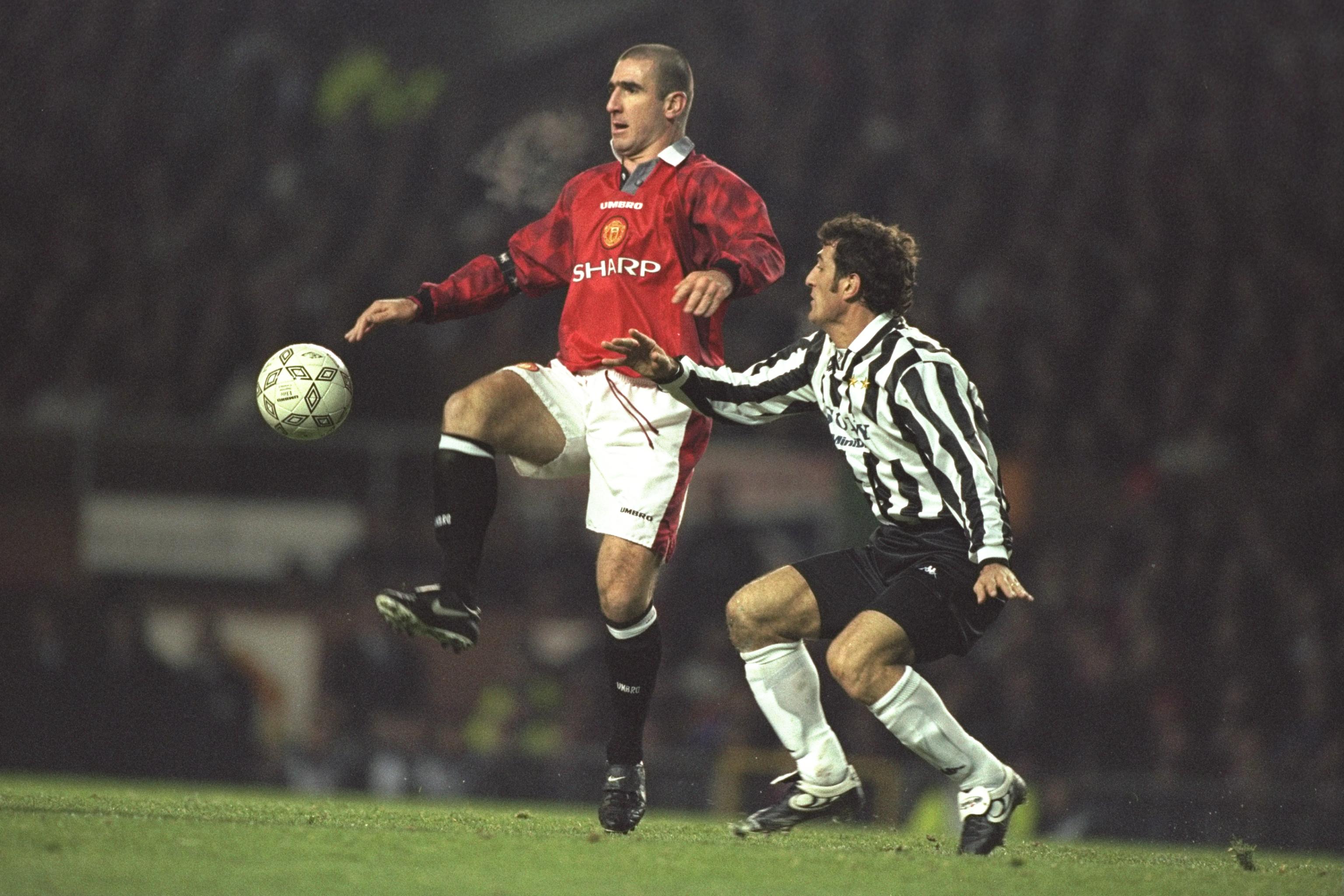 20 Nov 1996: Eric Cantona of United (left) gets to the ball ahead of Ciro Ferrara of Juventus during the champions league match between Manchester United and Juventus at Old Trafford, Manchester. Juventus won 0-1. Mandatory Credit: Graham Chadwick/Allspor