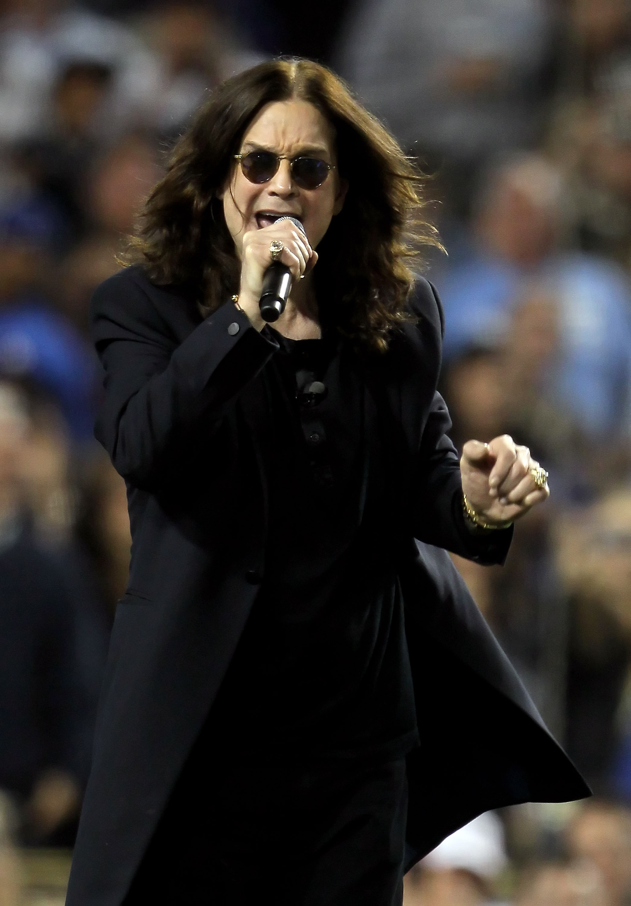 LOS ANGELES, CA - JUNE 11:  Singer-songwriter Ozzy Osbourne tries to lead the fans into the Guiness Book of World Records for the all-time loudest and longest scream during an interleague game between the Los Angeles Angels of Anaheim and the Los Angeles