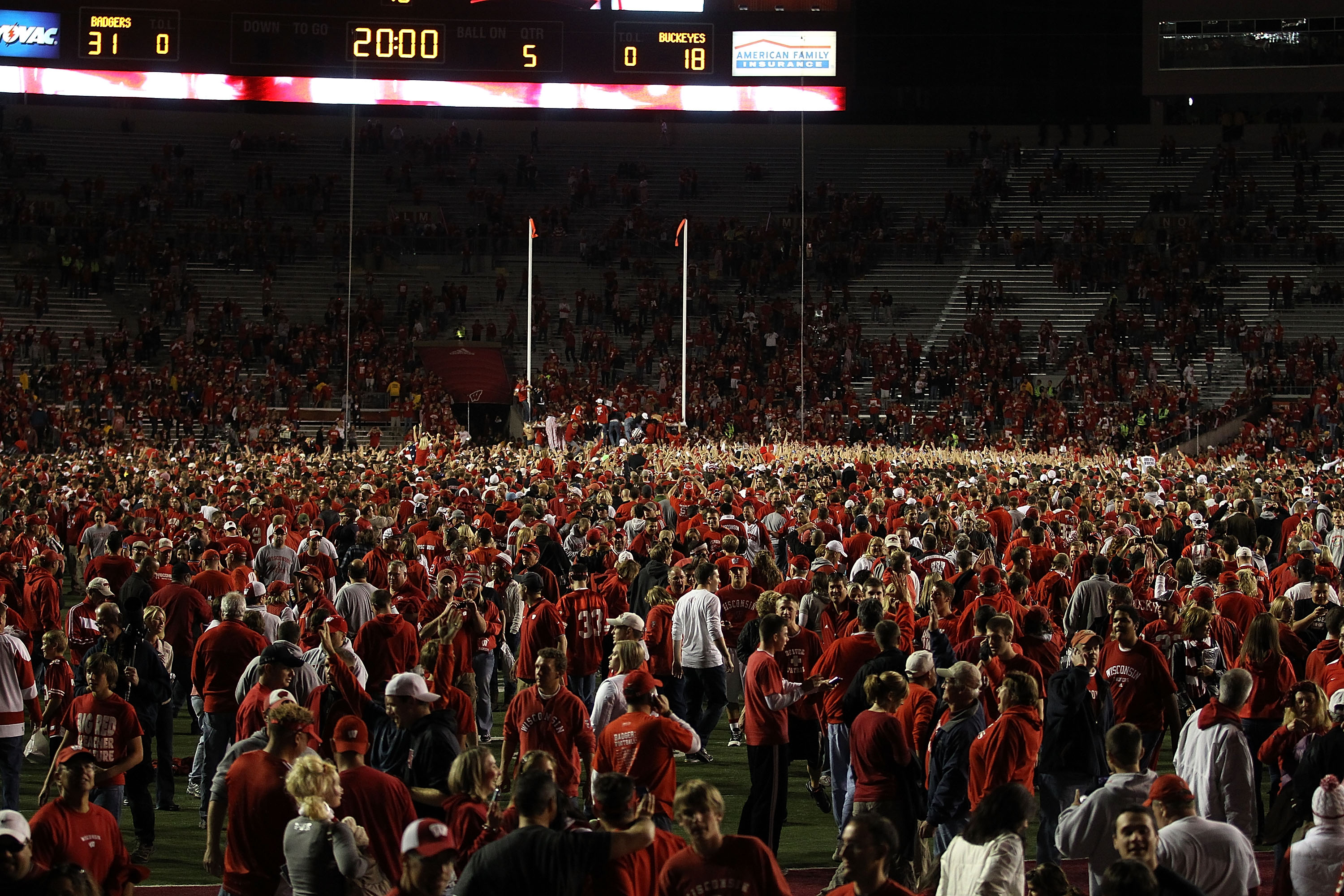 MADISON, WI - OCTOBER 16: Fans of the Wisconsin Badgers poor on to the field following a win against the Ohio State Buckeyes at Camp Randall Stadium on October 16, 2010 in Madison, Wisconsin. Wisconsin defeated Ohio State 31-18. (Photo by Jonathan Daniel/