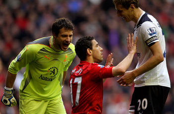 LIVERPOOL, ENGLAND - MAY 15:  Maxi Rodriguez of Liverpool incurs the wrath of Carlo Cudicini (L) and Michael Dawson (R) of Spurs during the Barclays Premier League match between Liverpool and Tottenham Hotspur at Anfield on May 15, 2011 in Liverpool, Engl