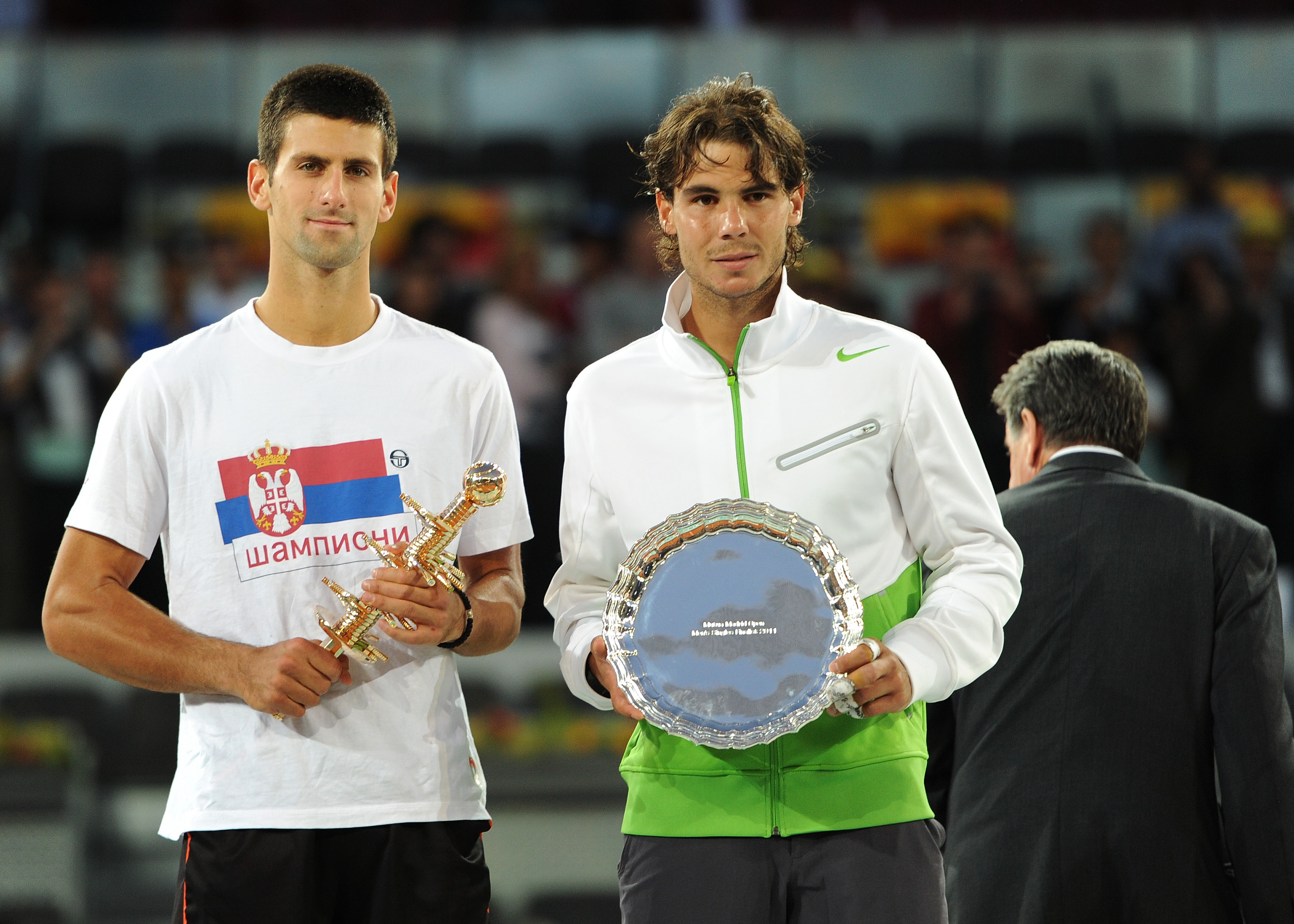 MADRID, SPAIN - MAY 08:  Novak Djokovic (L) of Serbia holds the Ion Tiriac's trophy besides runner up Rafael Nadal of Spain during the price giving ceremony on day eight of the Mutua Madrilena Madrid Open Tennis on May 8, 2011 in Madrid, Spain.  (Photo by