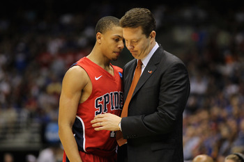 SAN ANTONIO, TX - MARCH 25:  Head coach Chris Mooney of the Richmond Spiders comforts Kevin Smith #12 after the southwest regional of the 2011 NCAA men's basketball tournament at the Alamodome on March 25, 2011 in San Antonio, Texas. Kansas defeated Richm
