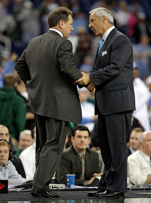 DETROIT - DECEMBER 03:  Roy Williams the Head Coach of the North Carolina Tar Heels and Tom Izzo the Head Coach of the Michigan State Spartans greet after the game against on December 3, 2008 at Ford Field in Detroit, Michigan.  (Photo by Andy Lyons/Getty