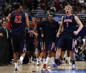 ANAHEIM, CA - MARCH 24:  Kyryl Natyazhko #1 celebrates with Jamelle Horne #42 of the Arizona Wildcats as he walks towards the bench against the Duke Blue Devils during the west regional semifinal of the 2011 NCAA men's basketball tournament at the Honda C