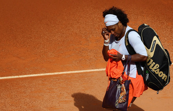 MADRID, SPAIN - MAY 11:  Serena Williams of the USA shows her dejection as she leaves the court after retiring injured from her first round match against Francesca Schiavone of Italy during the Madrid Open tennis tournament at the Caja Magica on May 11, 2