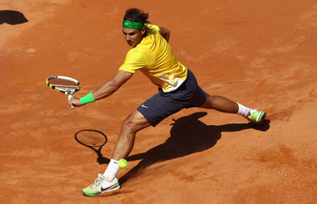 ROME, ITALY - MAY 13:  Rafael Nadal of Spain slides to play a backhand during his quarter final match against Marin Cilic of Croatia during day six of the Internazoinali BNL D'Italia at the Foro Italico Tennis Centre  on May 13, 2011 in Rome, Italy.  (Pho