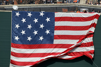 BALTIMORE, MD - APRIL 04:  An American flag is unveiled during opening day ceremonies between the Baltimore Orioles and the Detroit Tigers at Oriole Park at Camden Yards on April 4, 2011 in Baltimore, Maryland.  (Photo by Rob Carr/Getty Images)