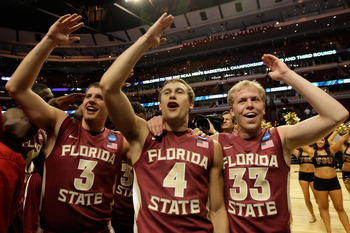 CHICAGO, IL - MARCH 20:  Luke Loucks #3, Deividas Dulkys #4 and Joey Moreau #33 of the Florida State Seminoles celebrate their 71-57 victory over the Notre Dame Fighting Irish during the third round of the 2011 NCAA men's basketball tournament at the Unit