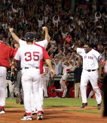 BOSTON - OCTOBER 8:  David Ortiz #34 of the Boston Red Sox runs to his teammates after hitting the game winning homerun to defeat the Anaheim Angels 8-6 in the 10th inning of Game 3 of the American League Division Series on October 8, 2004 at Fenway Park 