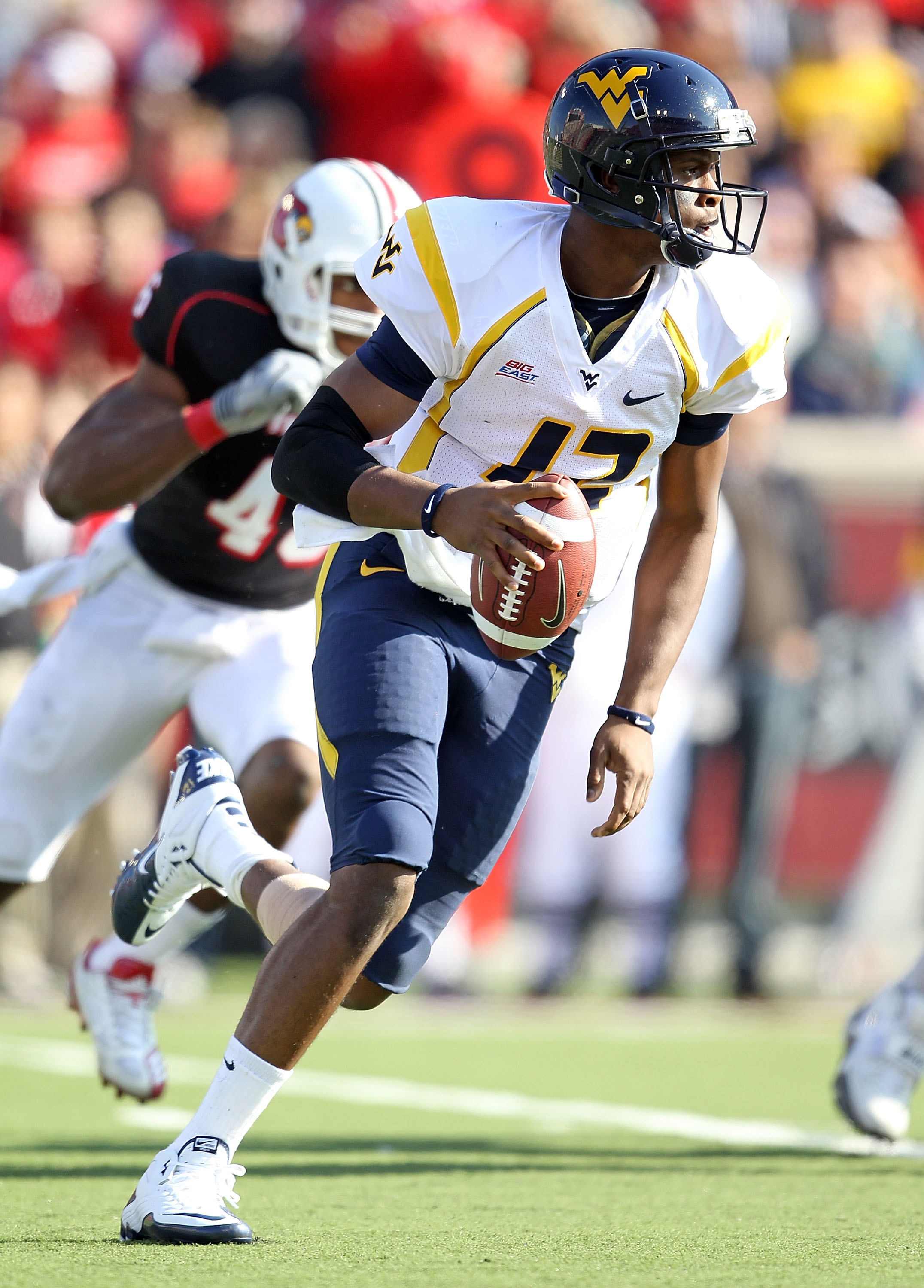 LOUISVILLE, KY - NOVEMBER 20:  Geno Smith#12 of the West Virginia Mountaineers runs with the ball during the Big East Conference game against the Louisville Cardinals at Papa John's Cardinal Stadium on November 20, 2010 in Louisville, Kentucky.  (Photo by