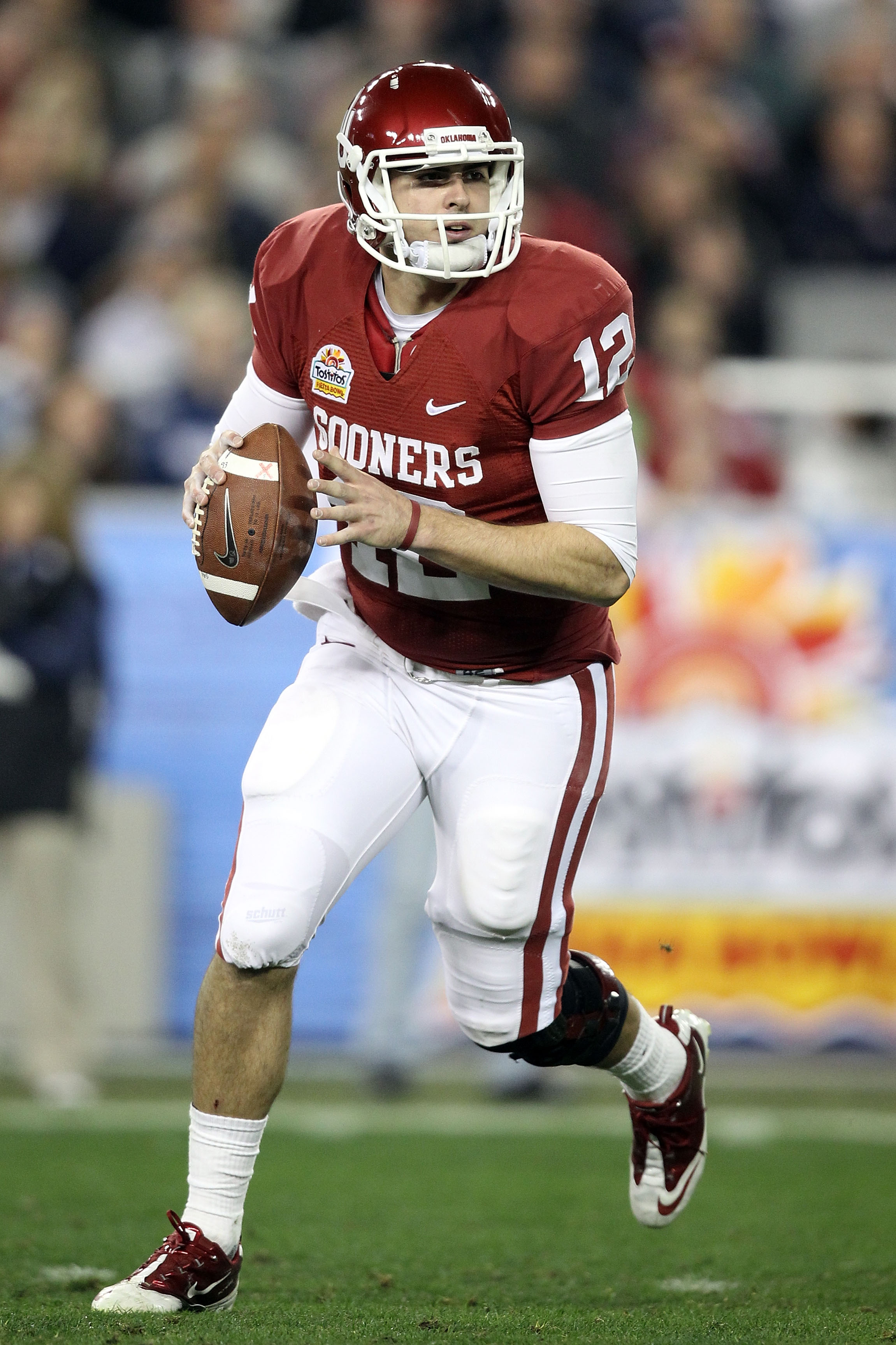 GLENDALE, AZ - JANUARY 01:  Landry Jones #12 of the Oklahoma Sooners throws the ball against the Connecticut Huskies during the Tostitos Fiesta Bowl at the Universtity of Phoenix Stadium on January 1, 2011 in Glendale, Arizona.  (Photo by Christian Peters