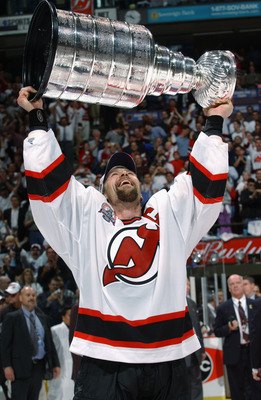 Scott Stevens of the New Jersey Devils takes the Stanley Cup from