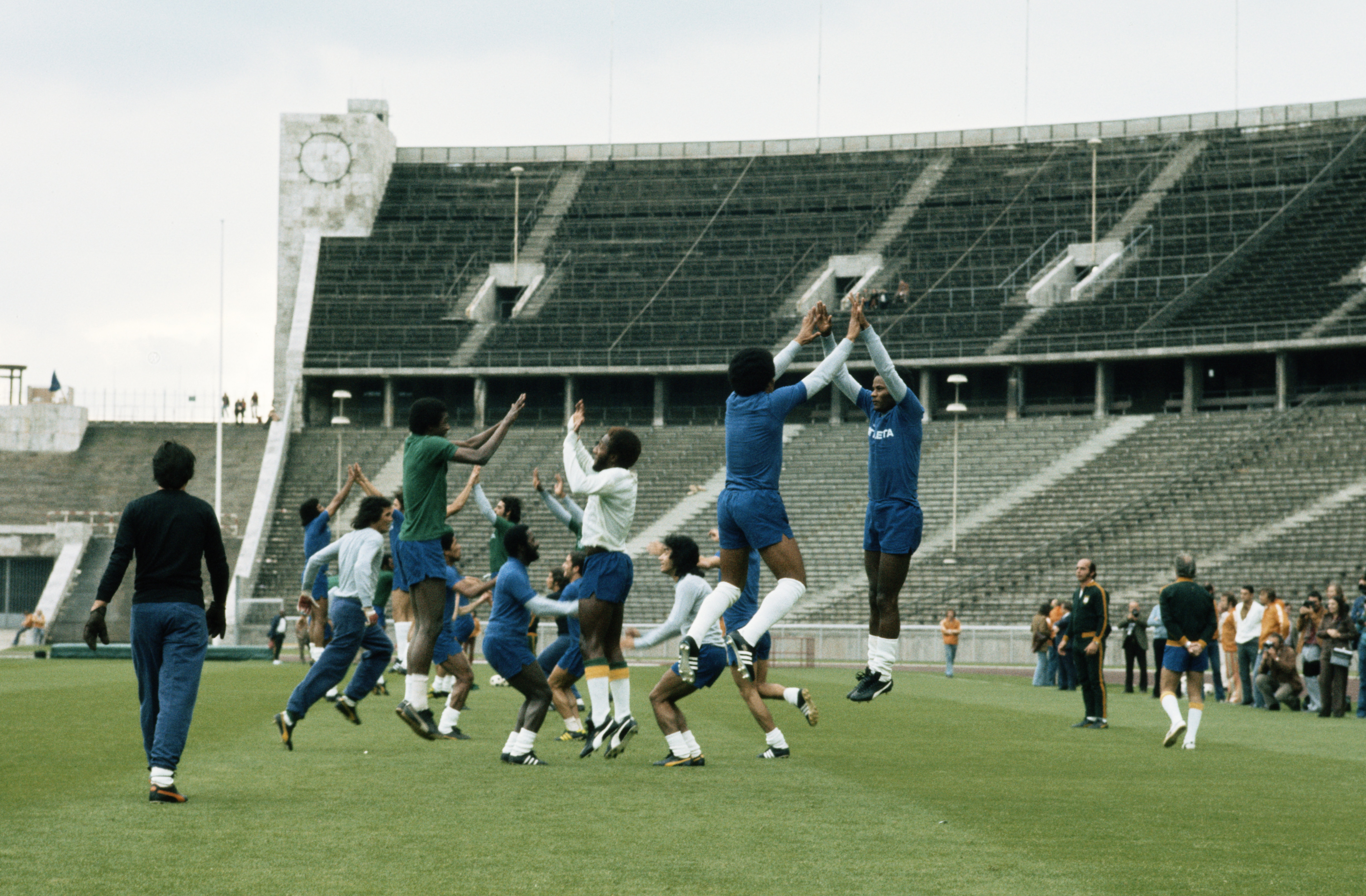 Mario Zagallo the coach for Brazil and the team trainer Admillo Chirol watch as Jairzinho and Marco Antonio in the foreground with the rest of the squad in training before the start of the 1974 FIFA World Cup in June 1974 at the Berlin Olympic Stadium in