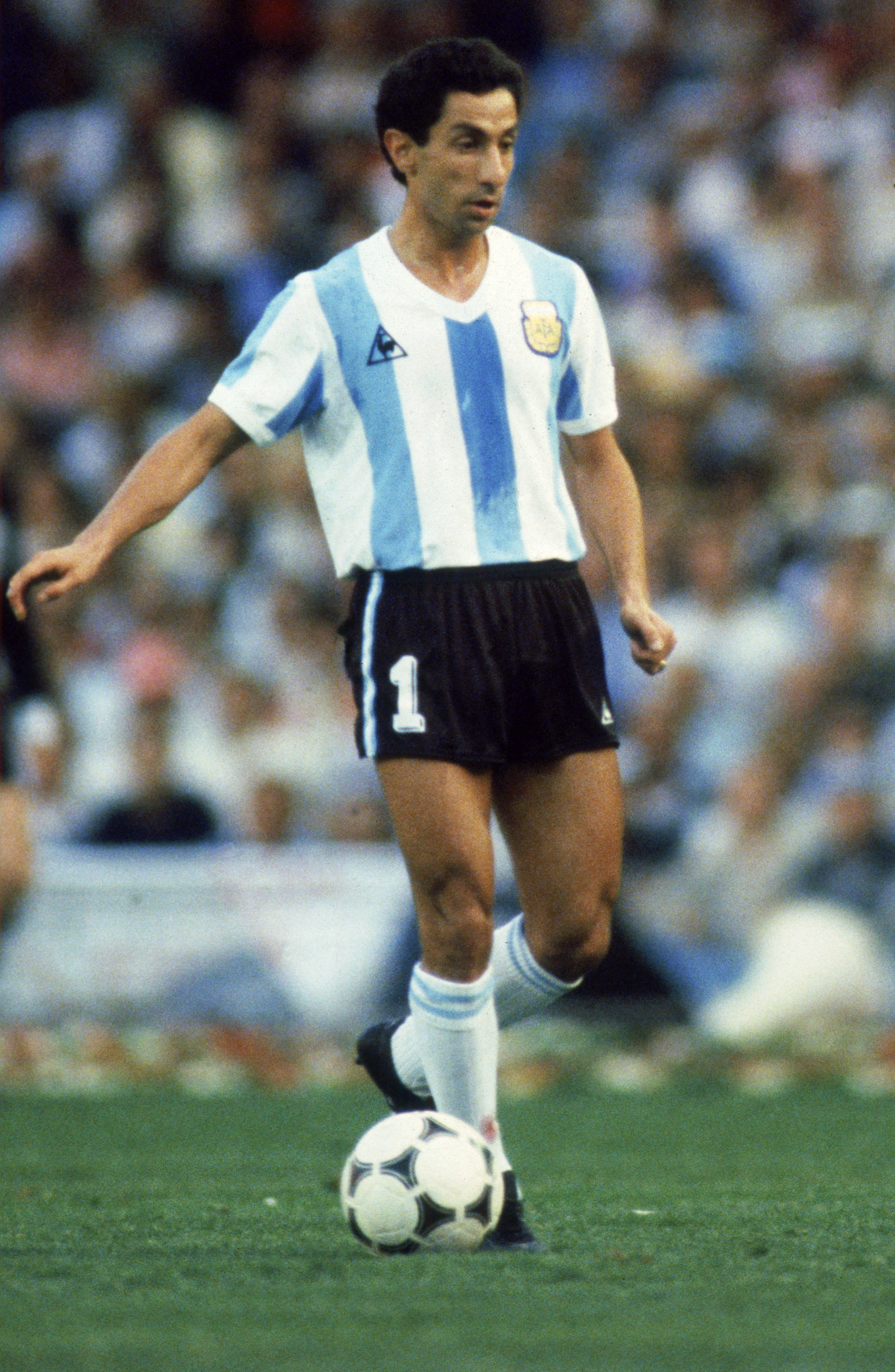 BARCELONA - JUNE 13:  Ossie Ardiles of Argentina runs with the ball during the FIFA World Cup Finals 1982 Group C match between Argentina and Belgium held on June 13, 1982 at the Nou Camp, in Barcelona, Spain. Belgium won the match 1-0. (Photo by Steve Po